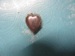 หลวงปู่แหวนรูปหัวใจเหรียญเล็กเลี่ยมนาคเก่า